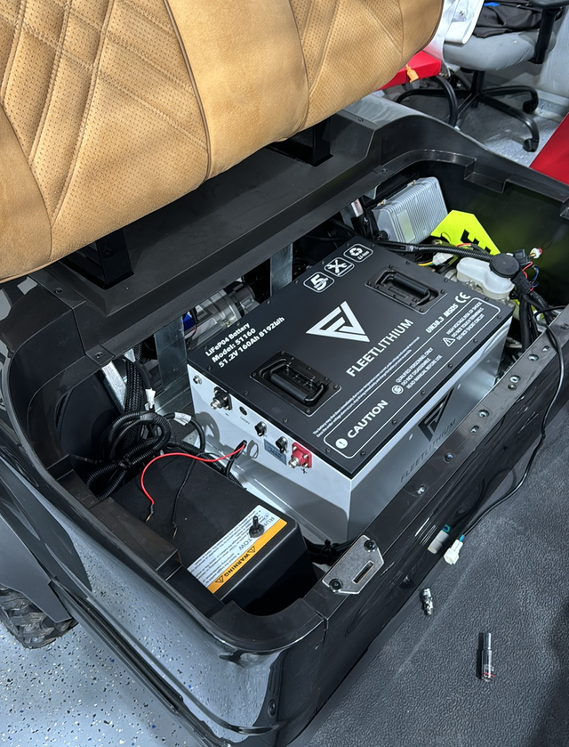 Fleet Lithium 51V 168Ah Fleet Lithium Battery Bundle — NexGen BMS installed in a golf cart, showing the battery secured in the compartment alongside other vehicle components.