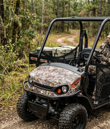 Camouflaged Textron Tracker Prowler EV (72V) in forested area, front view.